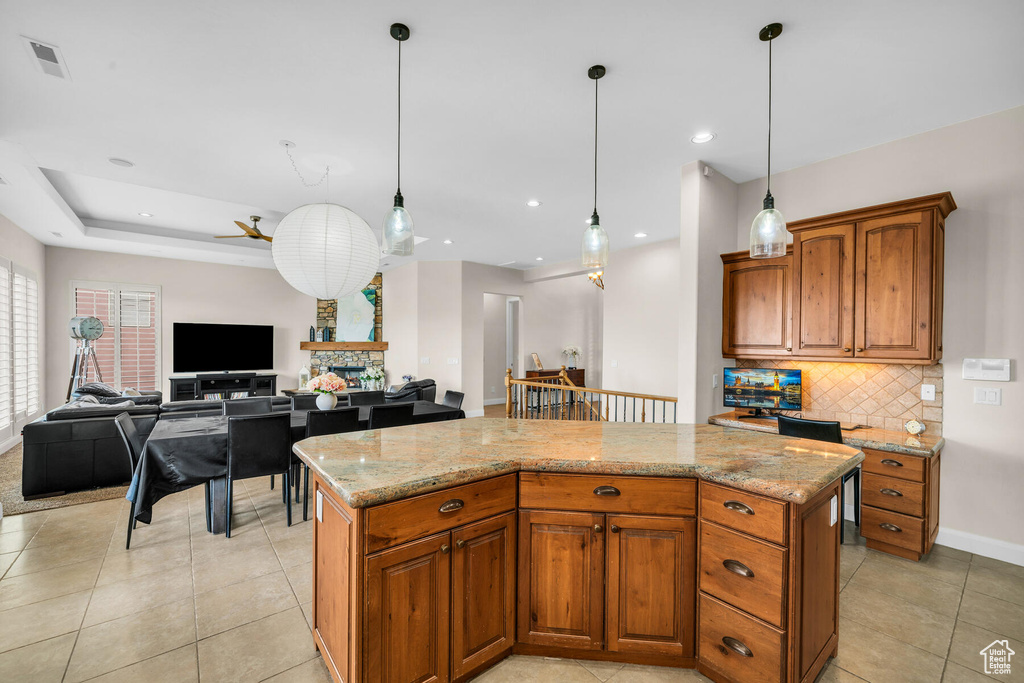 Kitchen with a center island, ceiling fan, and pendant lighting