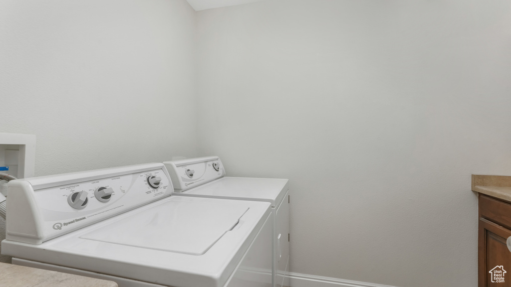 Washroom with tile floors and independent washer and dryer