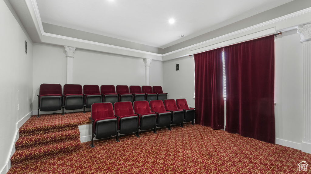 Carpeted home theater room featuring ornate columns