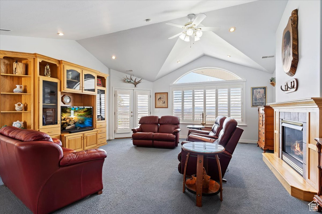 Carpeted living room featuring french doors, lofted ceiling, and ceiling fan