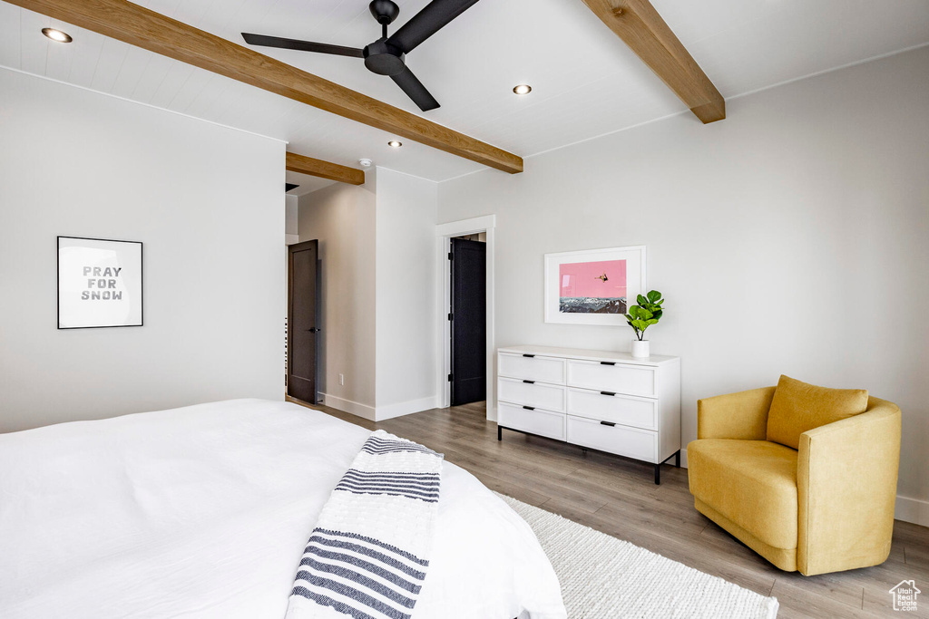 Bedroom featuring light hardwood / wood-style flooring, ceiling fan, and beamed ceiling
