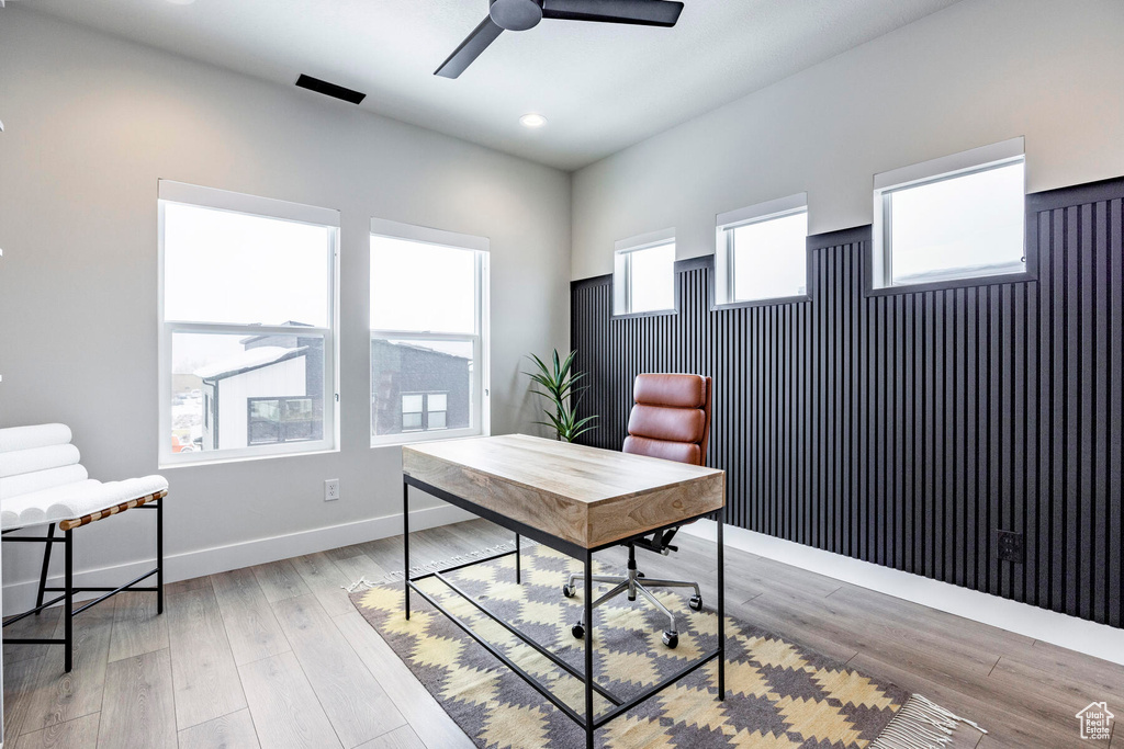 Office area with ceiling fan and light hardwood / wood-style flooring