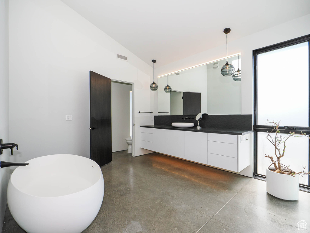 Bathroom with concrete floors and vanity