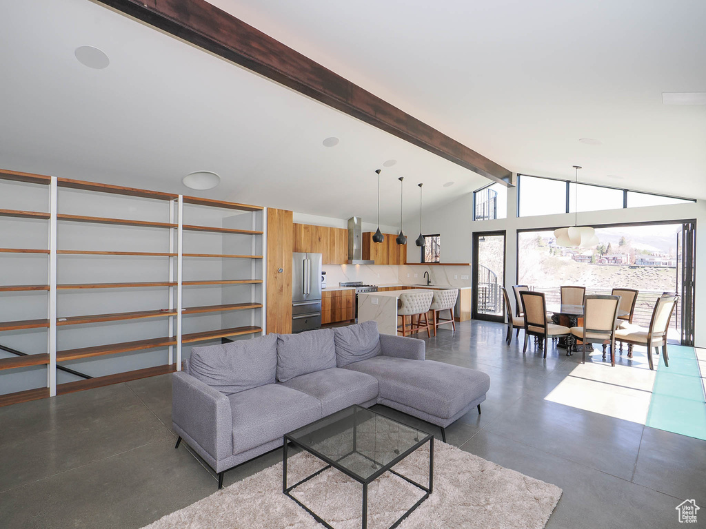 Living room featuring lofted ceiling with beams