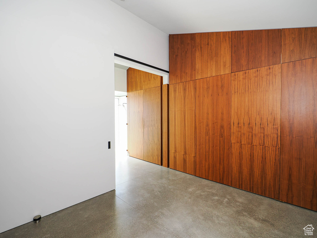 Spare room featuring wooden walls