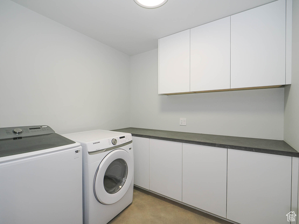 Washroom with washing machine and dryer and cabinets