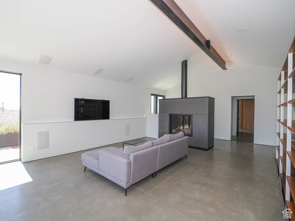 Living room featuring lofted ceiling with beams