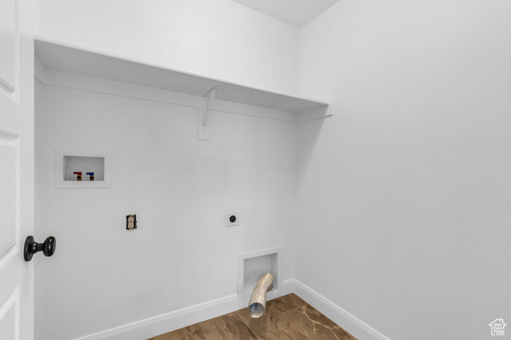 Laundry room with hardwood / wood-style flooring, hookup for a washing machine, and hookup for an electric dryer