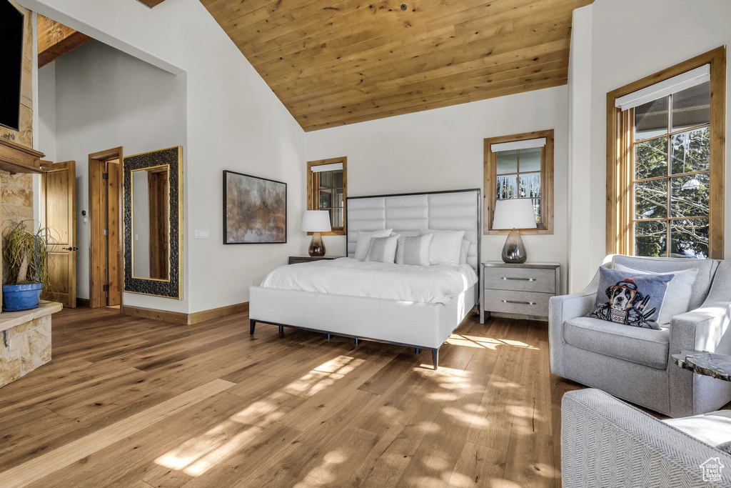 Bedroom featuring wood ceiling, high vaulted ceiling, and light hardwood / wood-style flooring