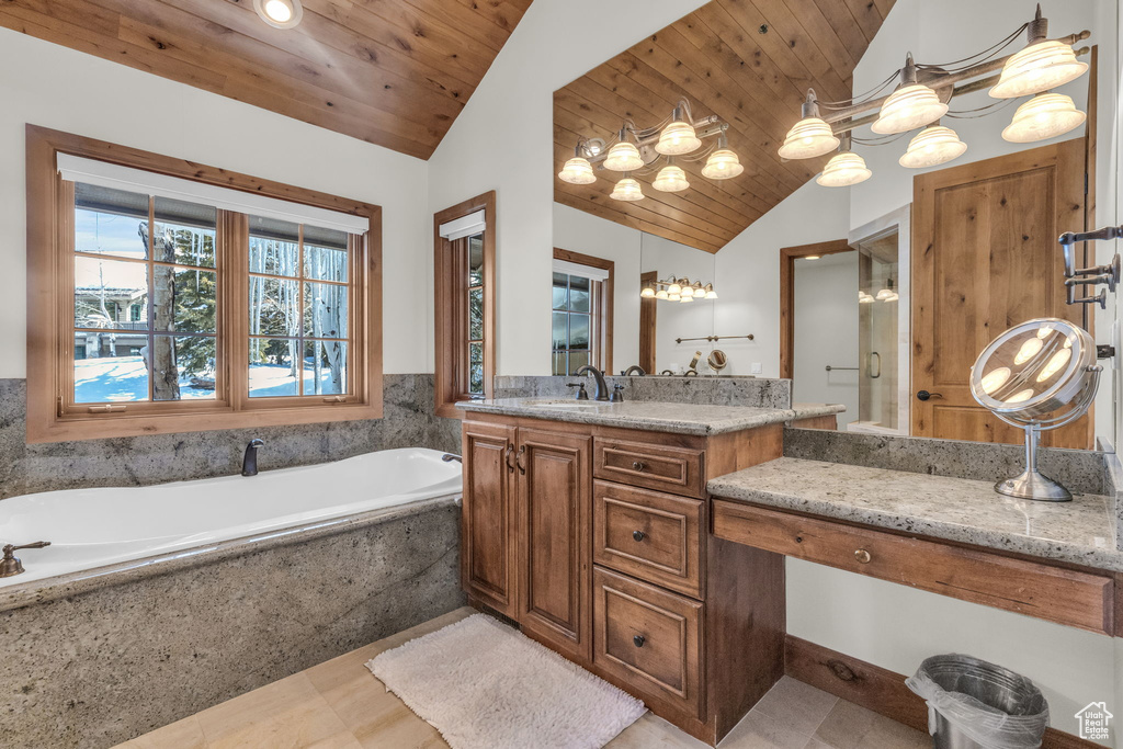 Bathroom featuring wood ceiling, tile floors, large vanity, and lofted ceiling