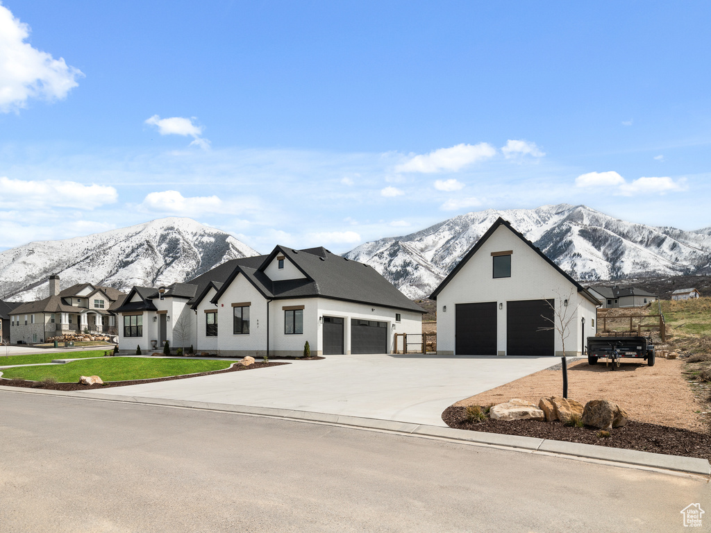 View of front of home featuring a mountain view and a garage