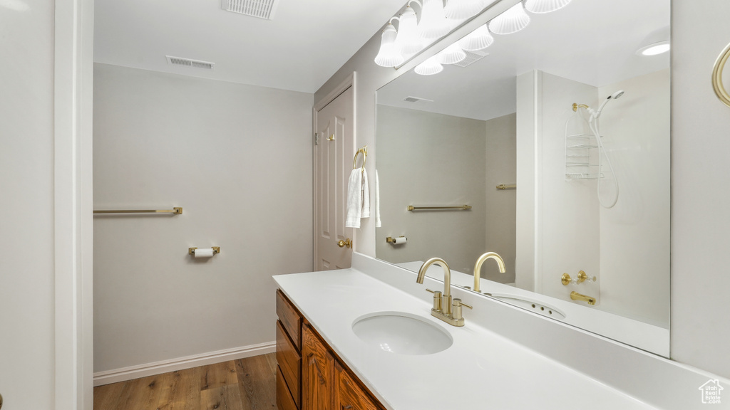 Bathroom featuring hardwood / wood-style floors and large vanity