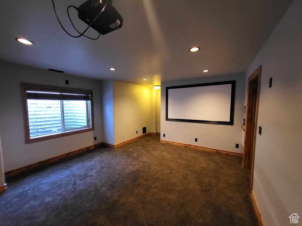 Home theater featuring dark colored carpet