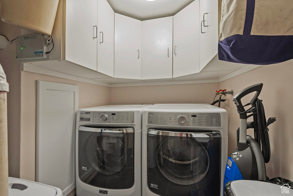 Laundry area with cabinets and washing machine and dryer