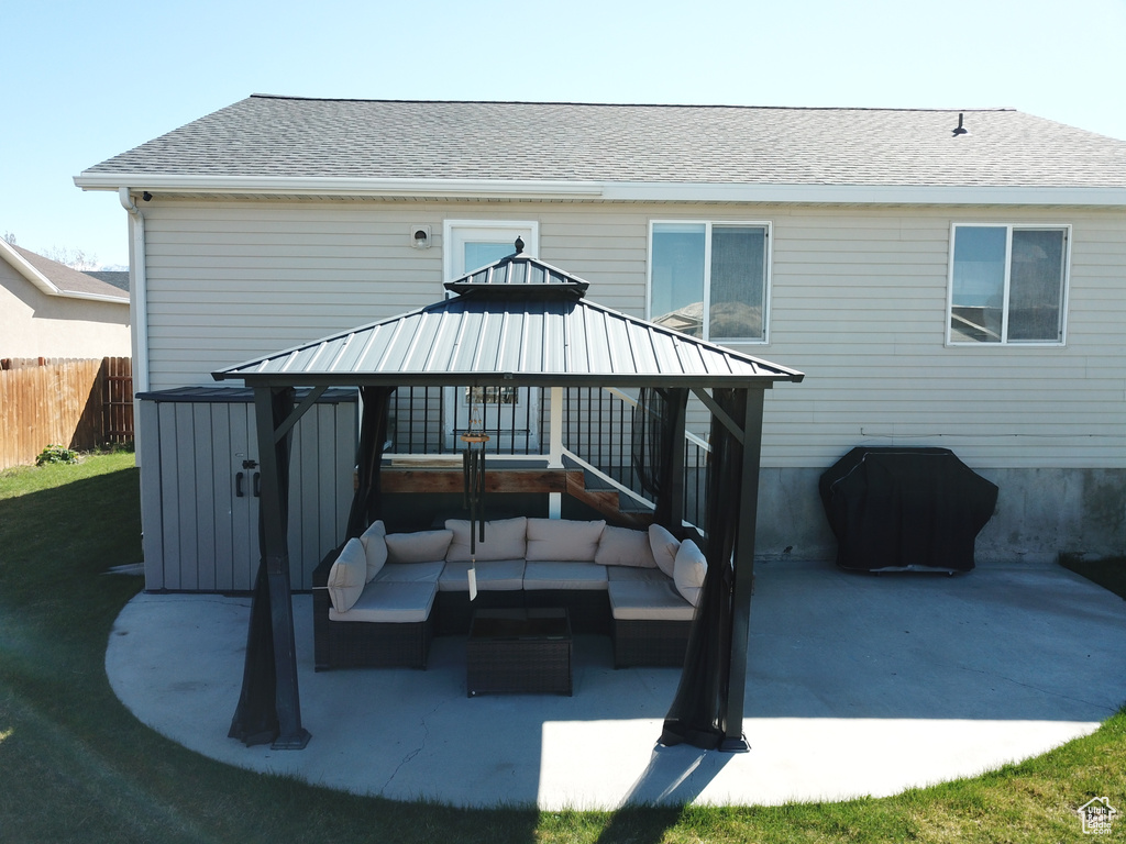 Back of house with outdoor lounge area, a patio, and a gazebo