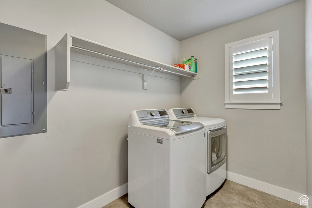 Laundry room featuring light tile flooring and separate washer and dryer