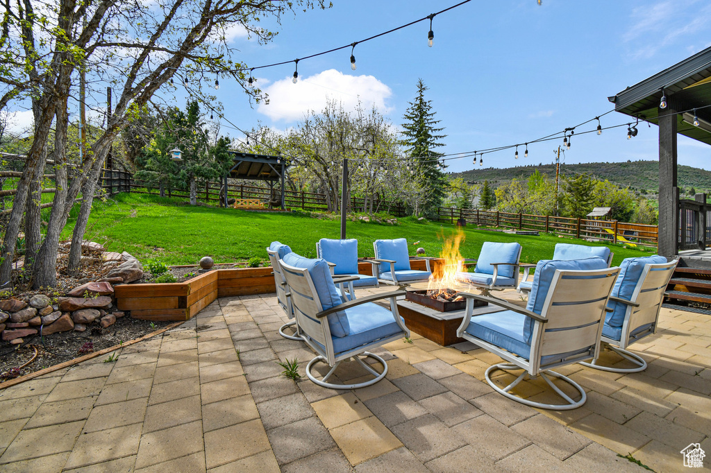 View of terrace featuring an outdoor fire pit