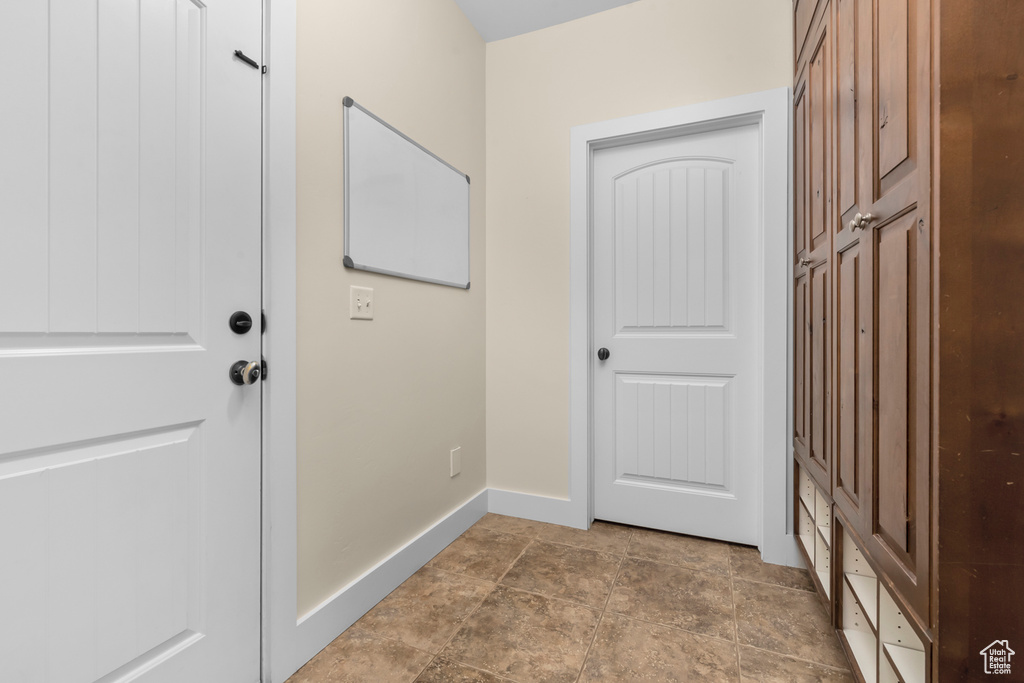Doorway with dark tile floors
