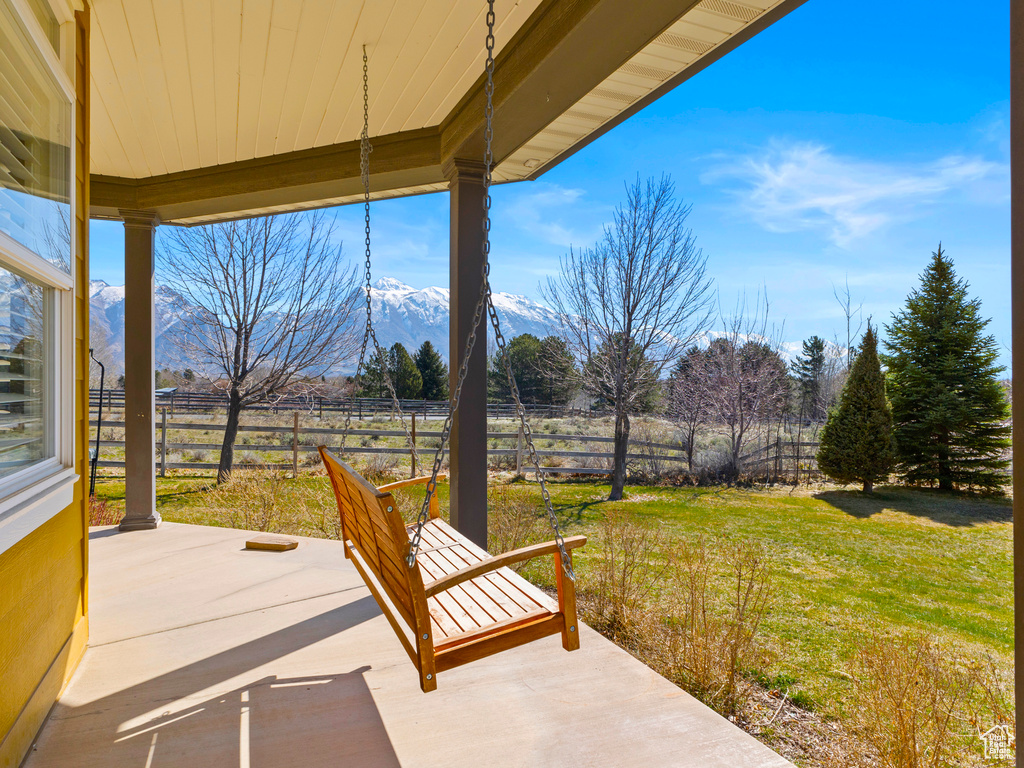 View of patio / terrace with a rural view and a mountain view