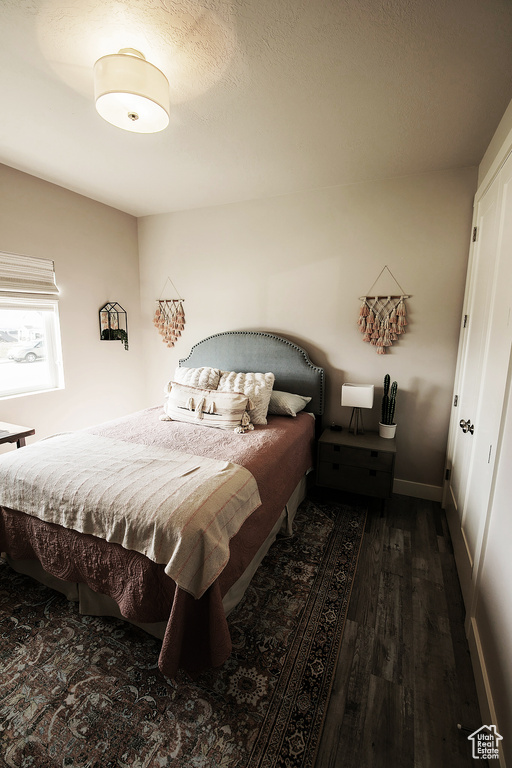 Bedroom with dark wood-type flooring