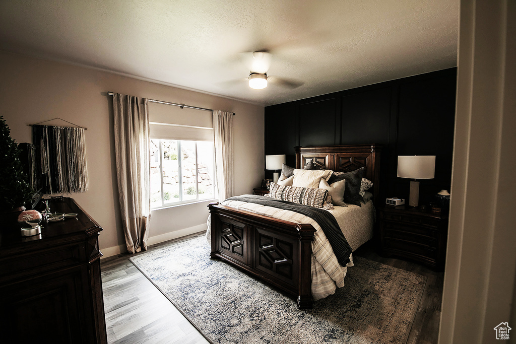 Bedroom featuring ceiling fan and light hardwood / wood-style flooring