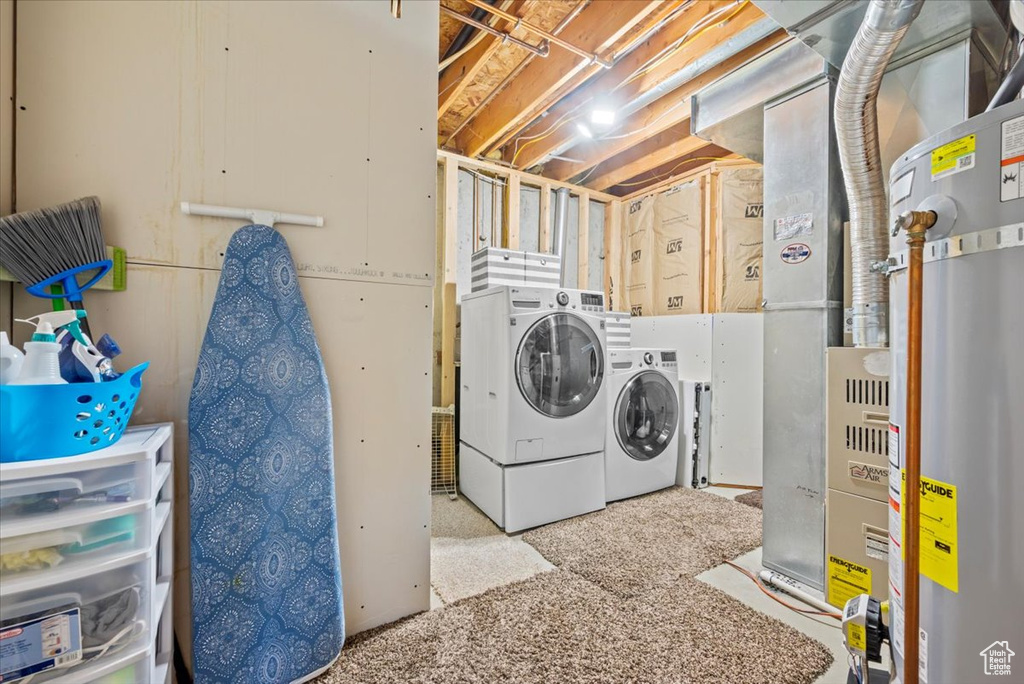Laundry area featuring washing machine and clothes dryer and water heater