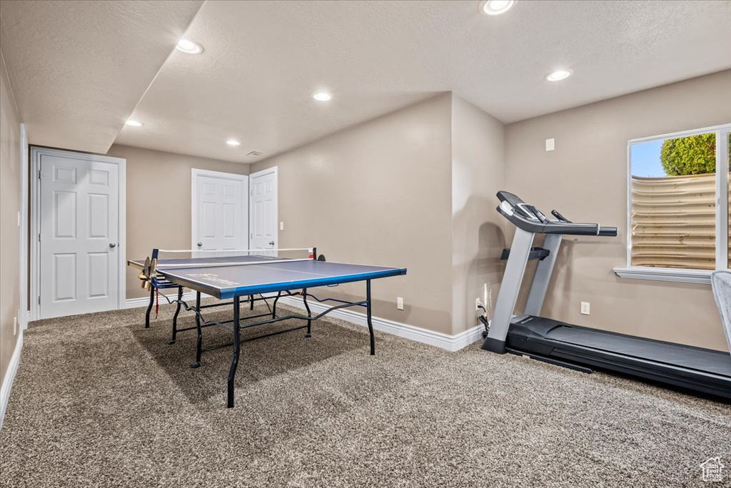 Game room featuring carpet flooring and a textured ceiling