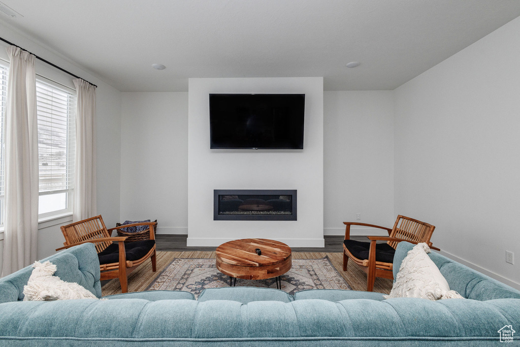 Living room with plenty of natural light and dark hardwood / wood-style floors