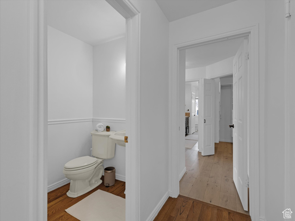 Bathroom with toilet and wood-type flooring
