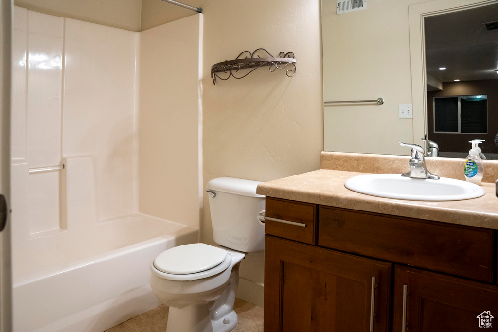 Full bathroom featuring tile flooring, shower / tub combination, vanity with extensive cabinet space, and toilet