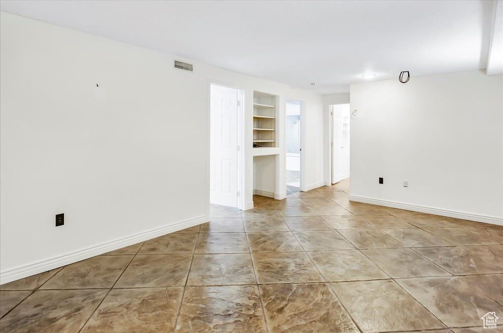 Spare room featuring light tile flooring