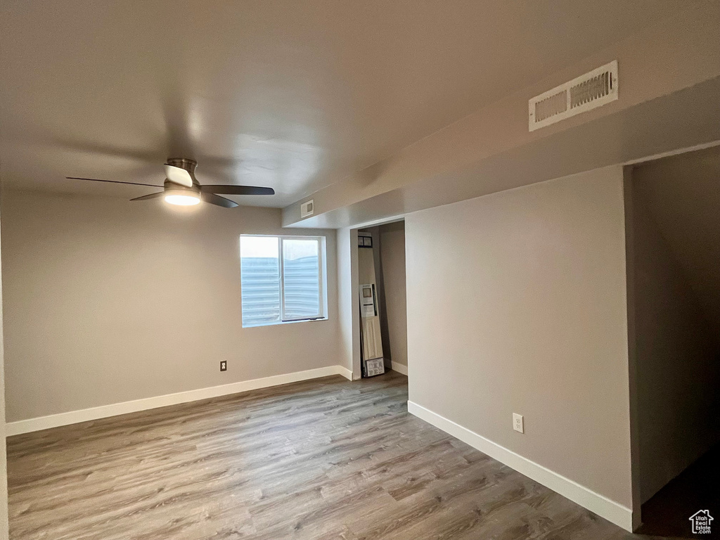 Empty room featuring ceiling fan and light hardwood / wood-style flooring