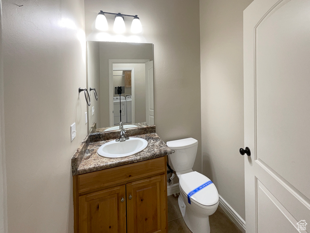 Bathroom featuring vanity and washing machine and dryer