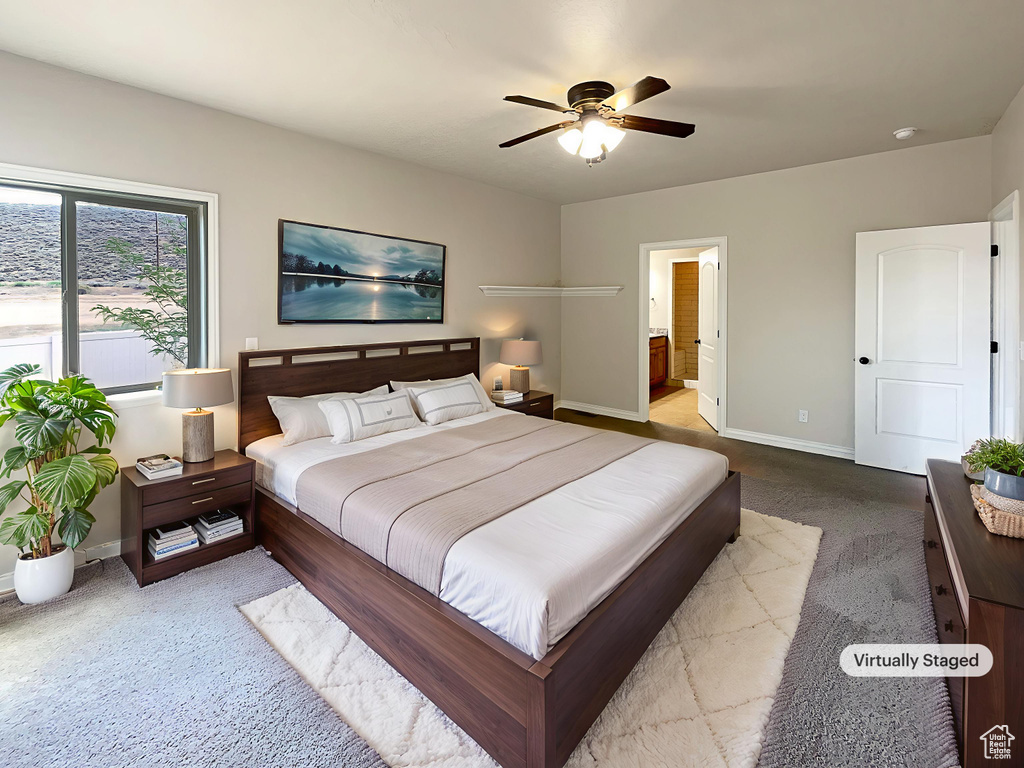Bedroom with carpet, connected bathroom, and a ceiling fan