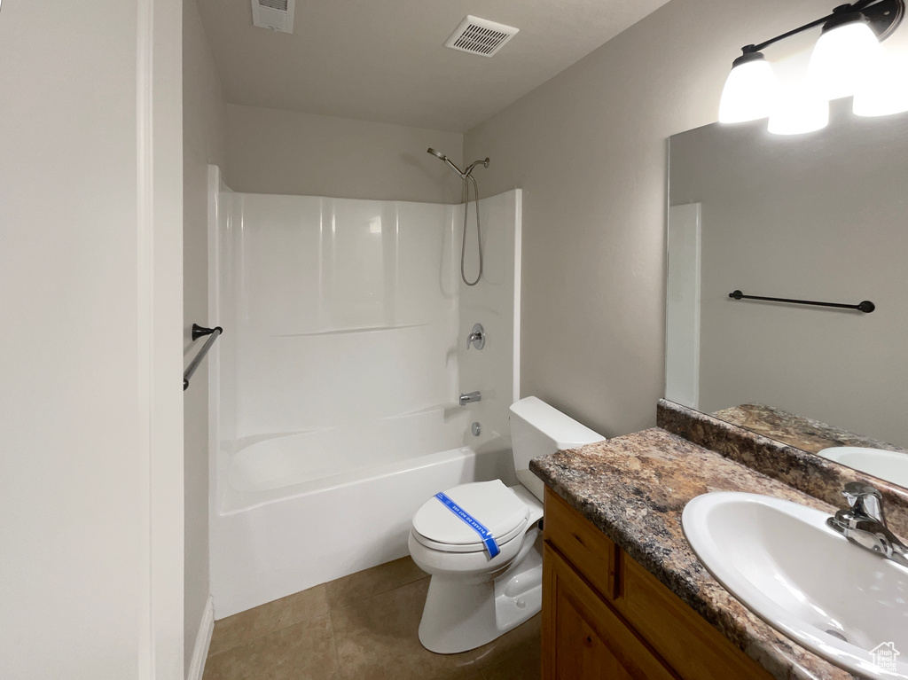 Bathroom featuring vanity, shower / washtub combination, and tile patterned floors