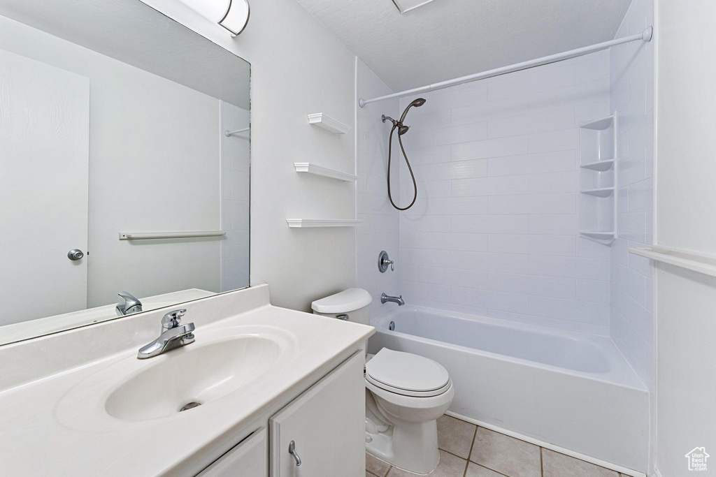 Full bathroom with washtub / shower combination, toilet, oversized vanity, and tile floors