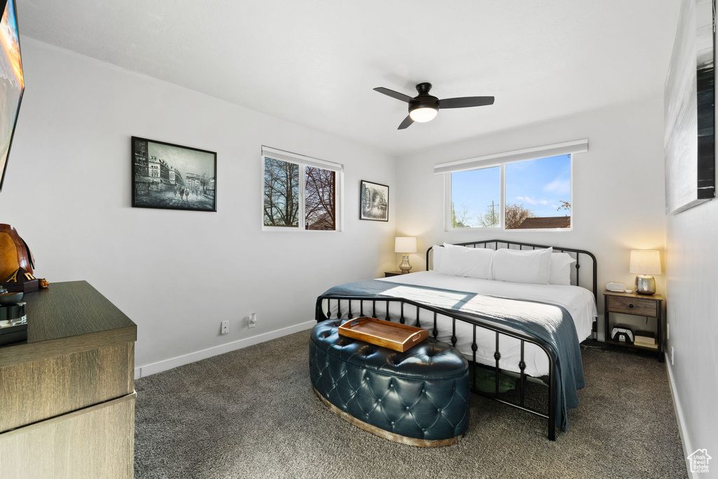 Bedroom featuring ceiling fan and dark carpet