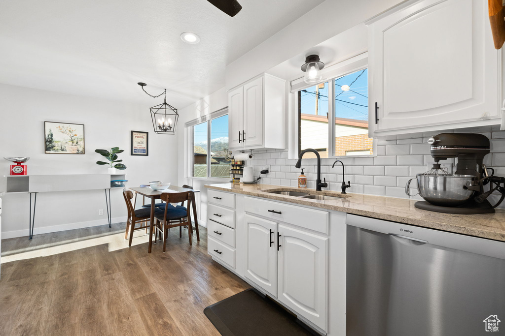 Kitchen featuring dark hardwood / wood-style floors, dishwasher, and white cabinetry