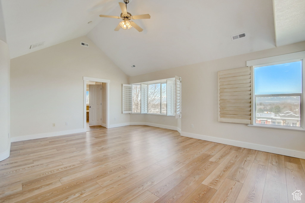 Unfurnished room featuring ceiling fan, a healthy amount of sunlight, and light hardwood / wood-style flooring