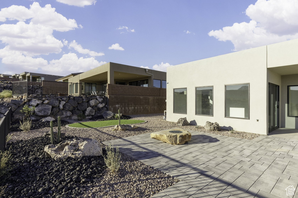 Exterior space featuring a fire pit and a patio