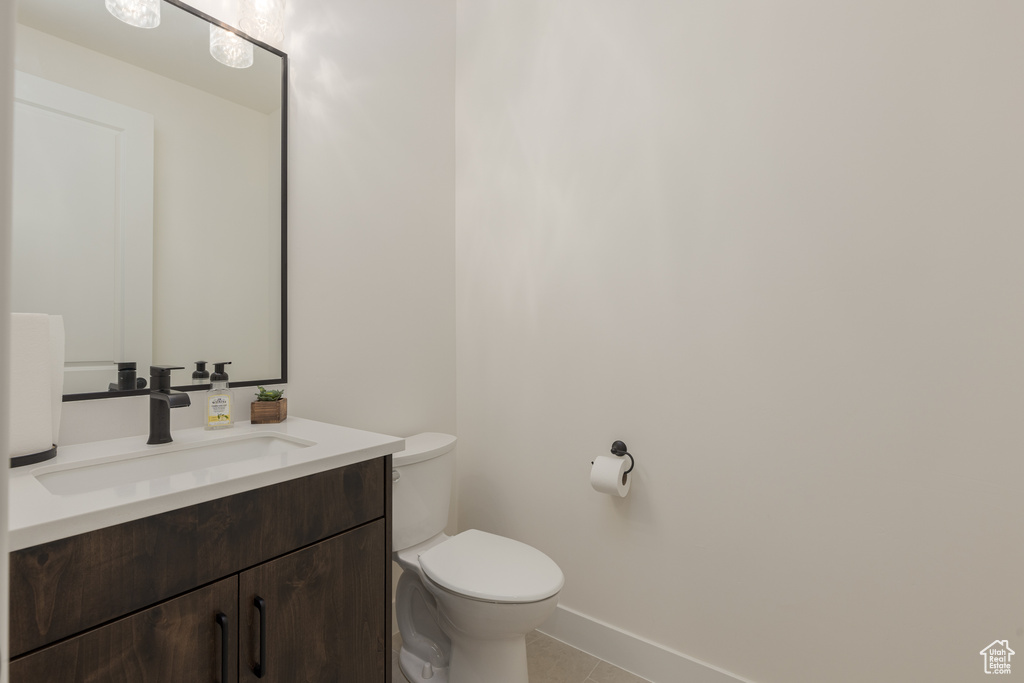 Bathroom featuring vanity, toilet, and tile patterned floors