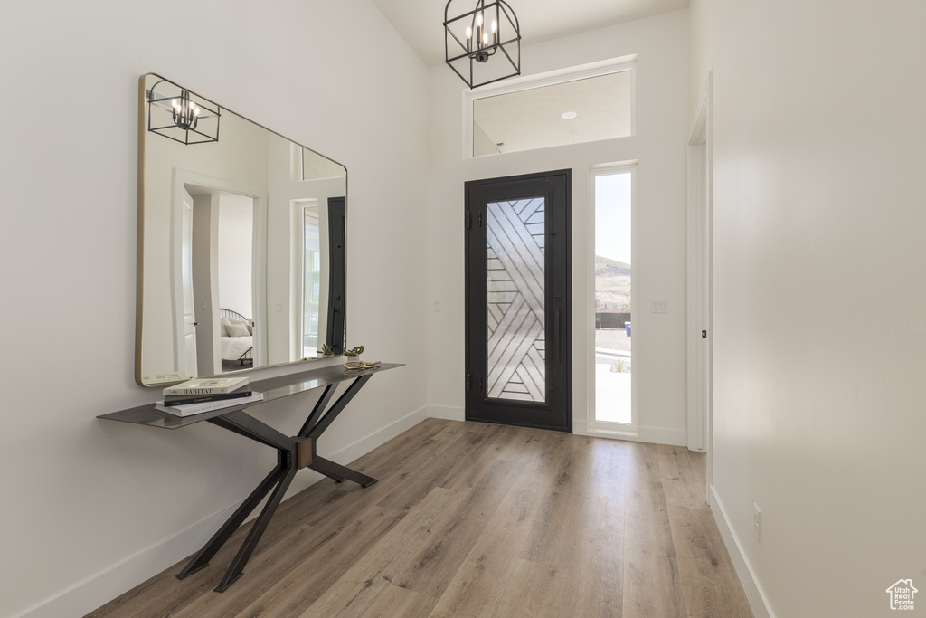 Foyer entrance featuring wood-type flooring and a notable chandelier