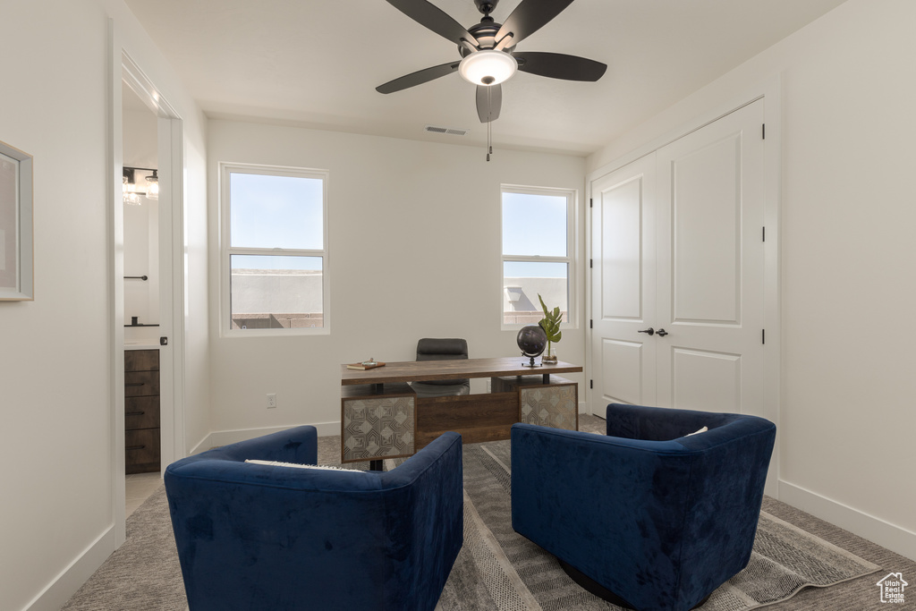 Sitting room with ceiling fan and carpet flooring