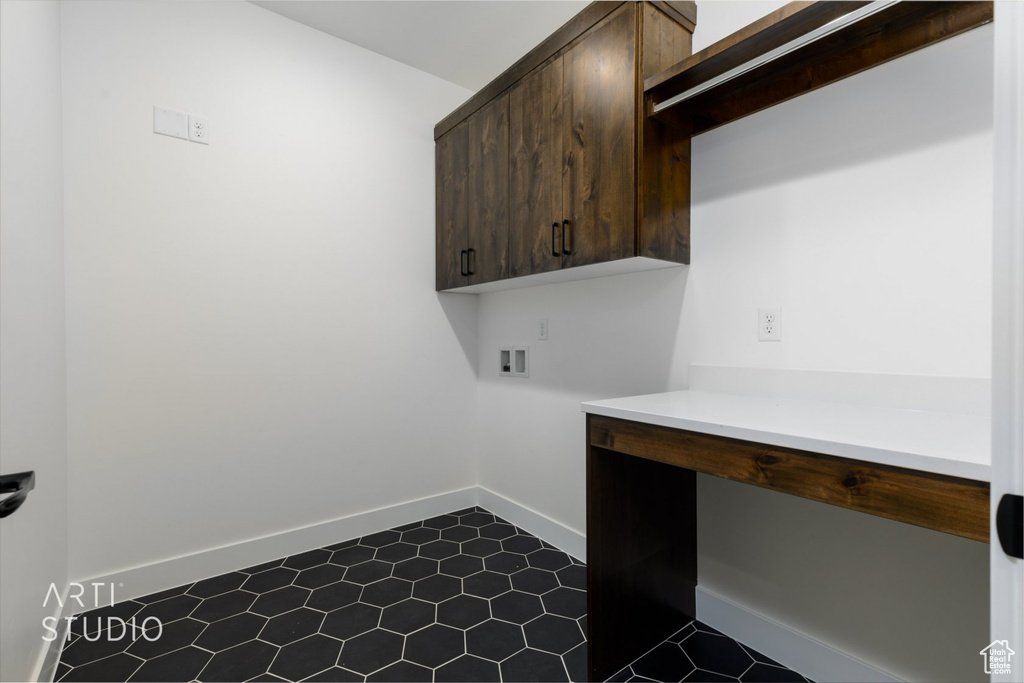 Laundry area featuring washer hookup, cabinets, and tile floors