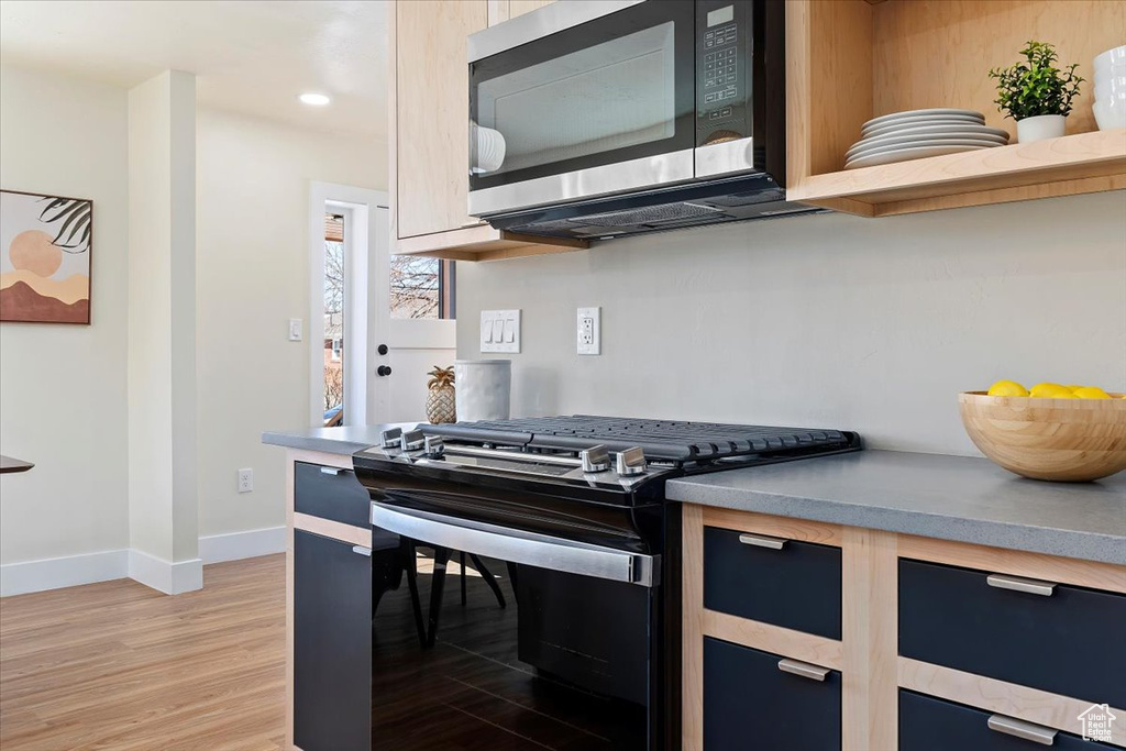 Kitchen featuring stainless steel appliances and light wood-type flooring