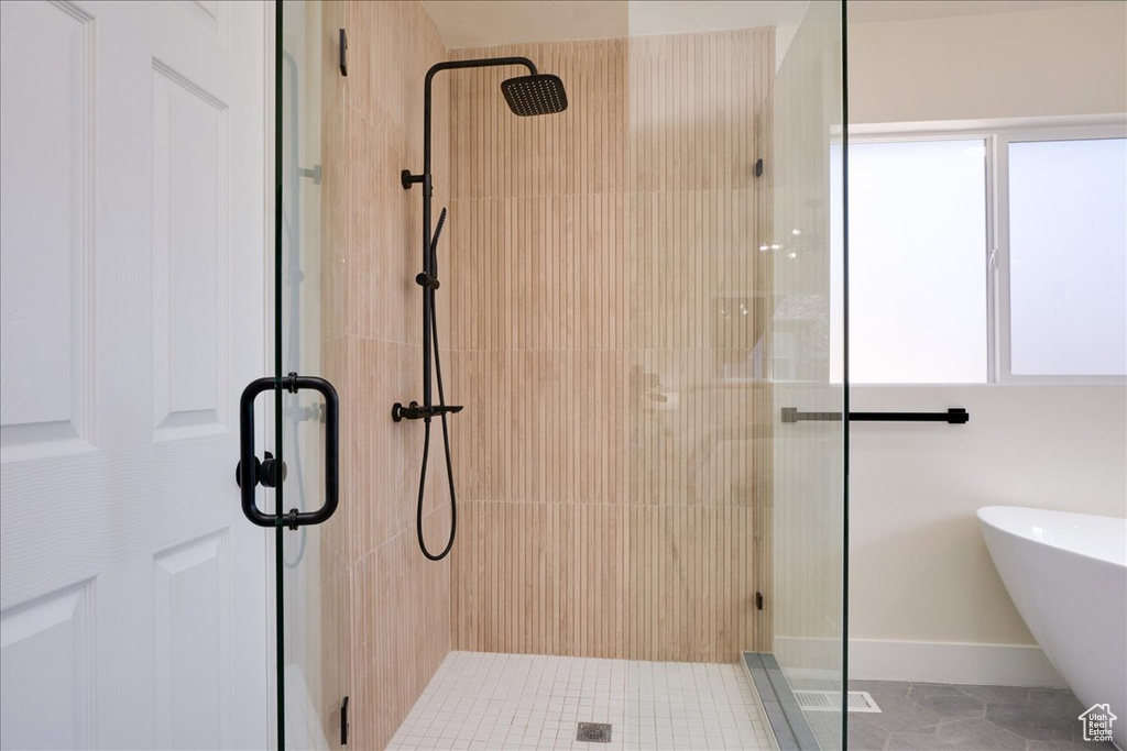 Bathroom featuring tile floors and a shower with shower door