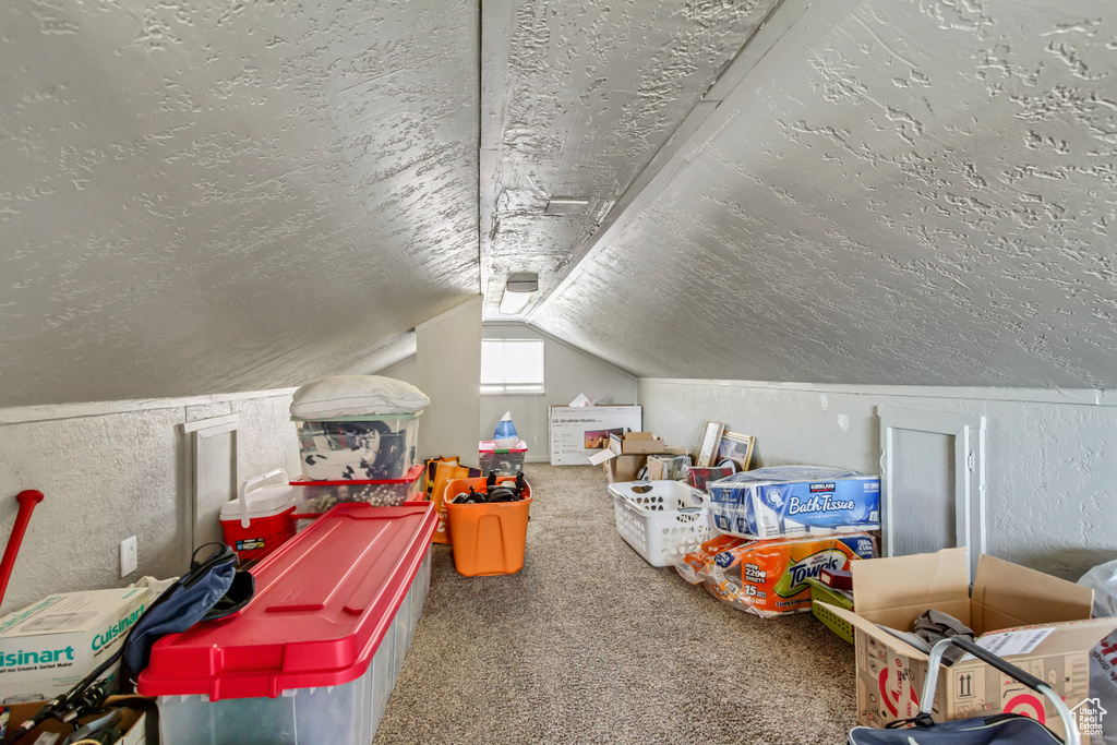 Game room with carpet floors and vaulted ceiling
