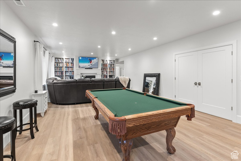 Rec room with built in shelves, pool table, and light wood-type flooring