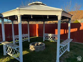 Exterior space featuring an outdoor fire pit and a gazebo