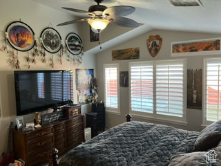 Bedroom featuring ceiling fan and vaulted ceiling